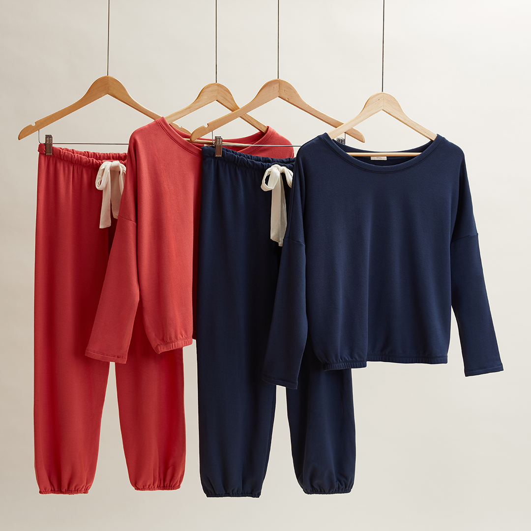 Pajamas tops and bottoms hanging styled and photographed by soft goods accessories photographer Kate Benson.