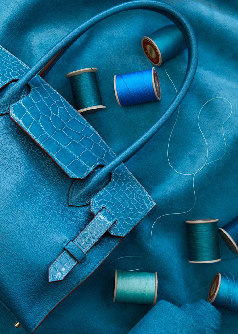 Kate Benson, accessories still life product photographer, photographed a creative overhead of a leather bag.