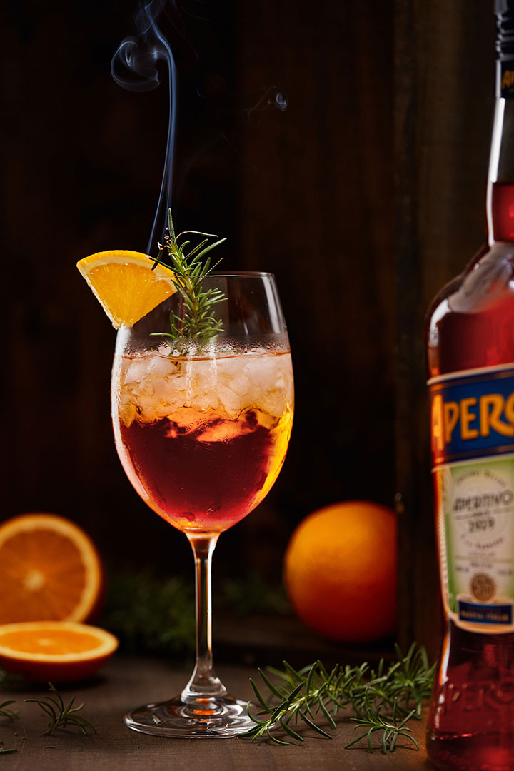 Drink with oranges and pine photographed by food and beverage photographer Kate Benson.