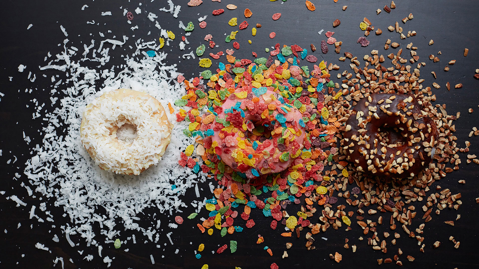 Vanilla and coconut, strawberry and fruit cereal, and chocolate and nut donuts styled and photographed by professional food and beverage photographer Kate Benson.