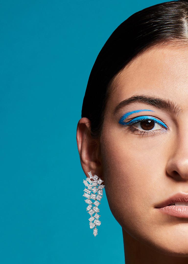 On model dangle diamond earring photographed by jewelry photographer Kate Benson.