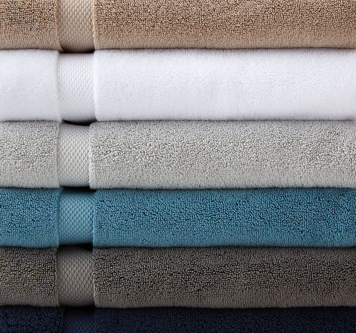 Stacked colored towels closeup photographed by still life photographer Kate Benson.