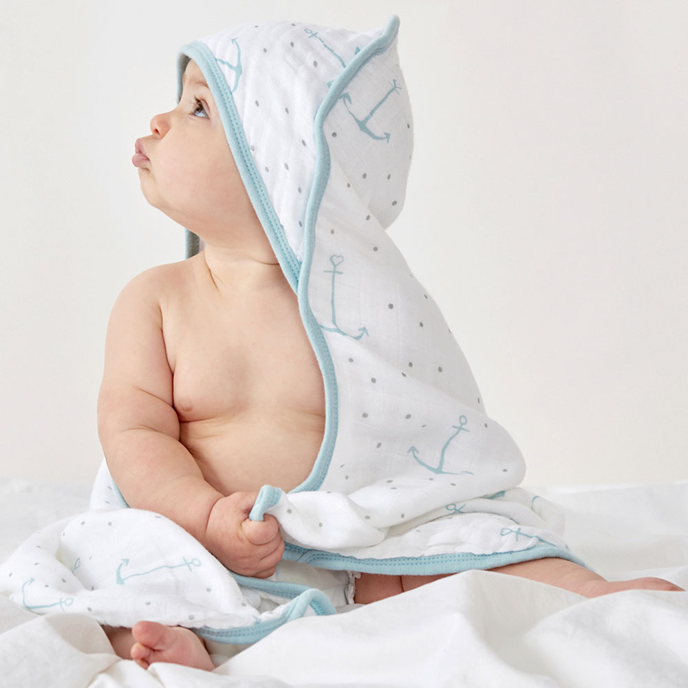 Baby wrapped in hooded towel photographed by professional product photographer Kate Benson.
