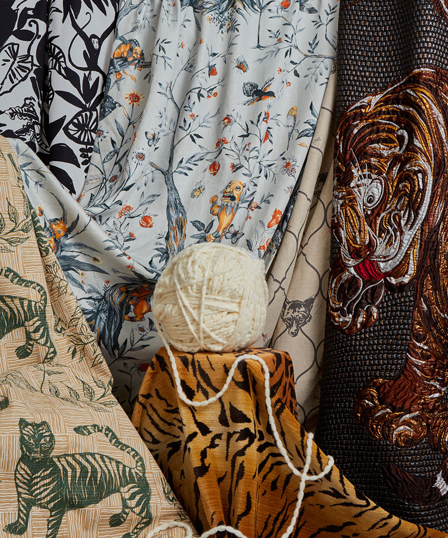 Tiger fabrics overlapping with ball of yarn photographed by editorial product photographer Kate Benson.