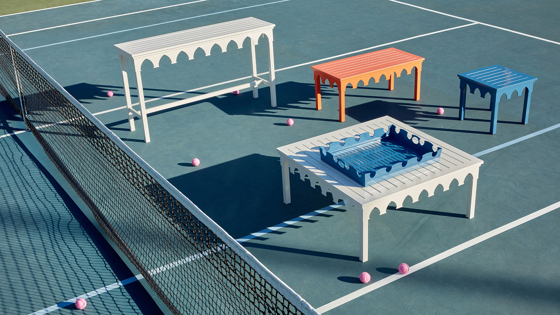 Outdoor tables and tray on tennis court photographed by professional product furniture photographer Kate Benson.