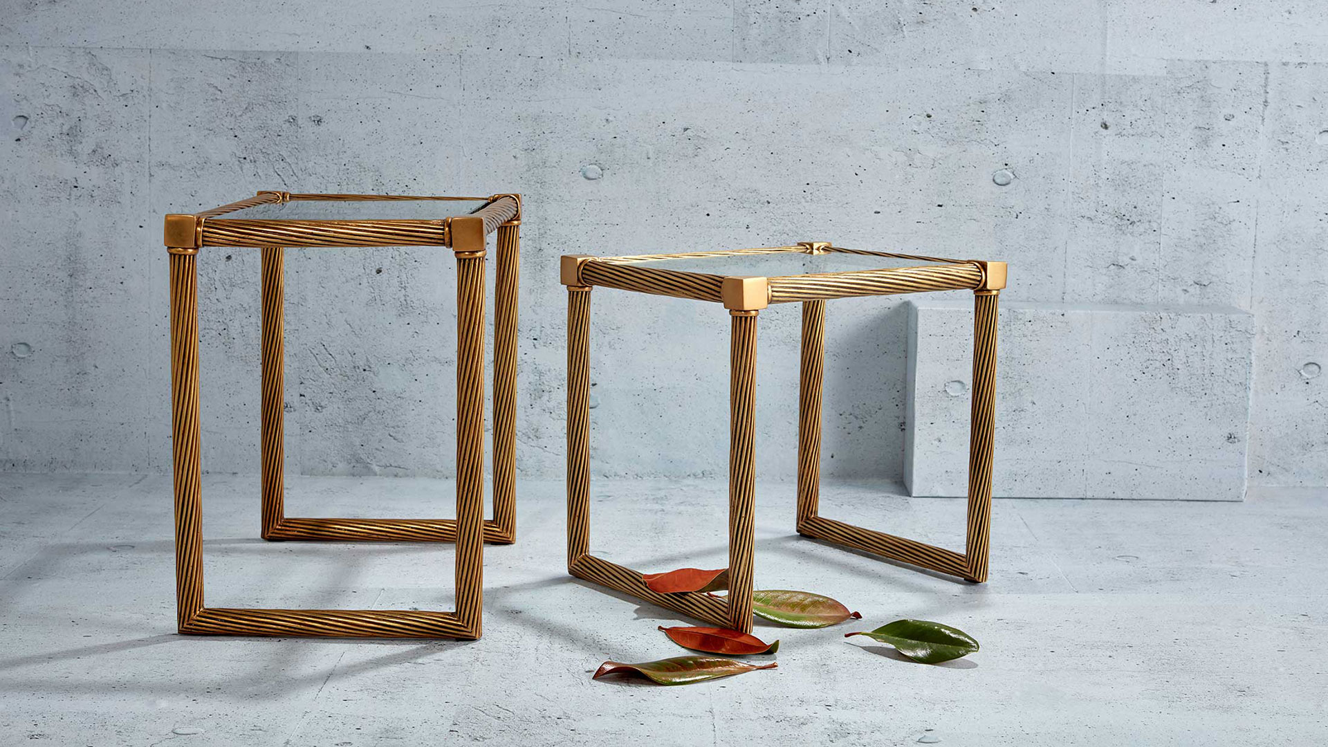 Mirror stacking side tables with concrete background photographed by professional editorial product photographer Kate Benson.