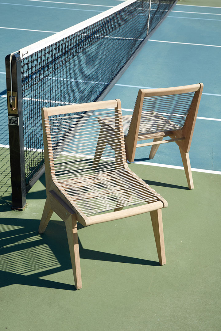 Wooden chairs on tennis court photographed by professional editorial product photographer Kate Benson.