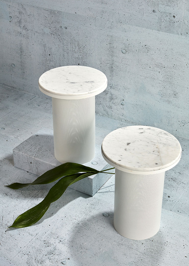 Marble topped end tables with concrete background photographed by professional still life photographer Kate Benson.