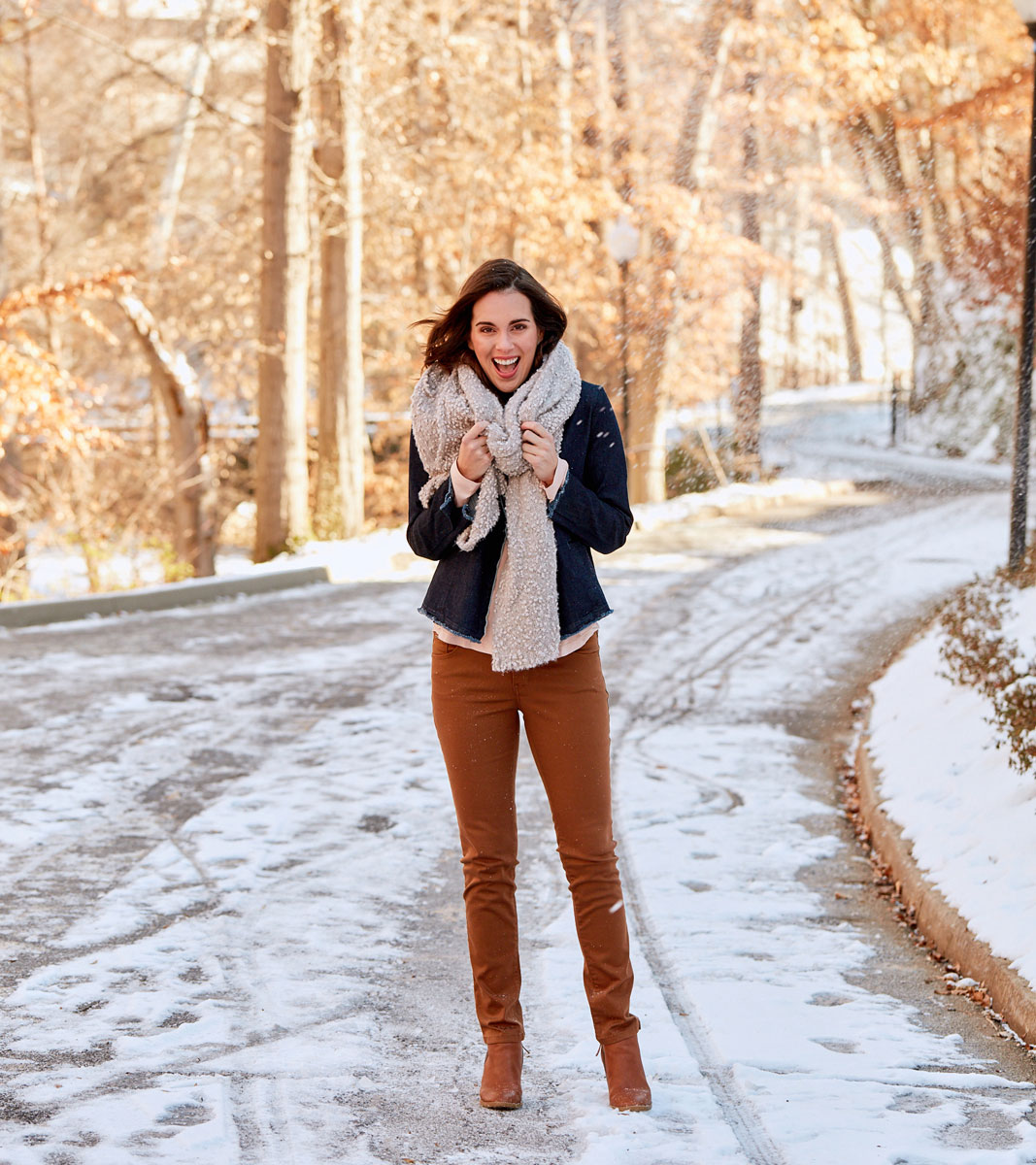 Model standing in snowy road photographed by professional commercial clothing photographer Kate Benson.