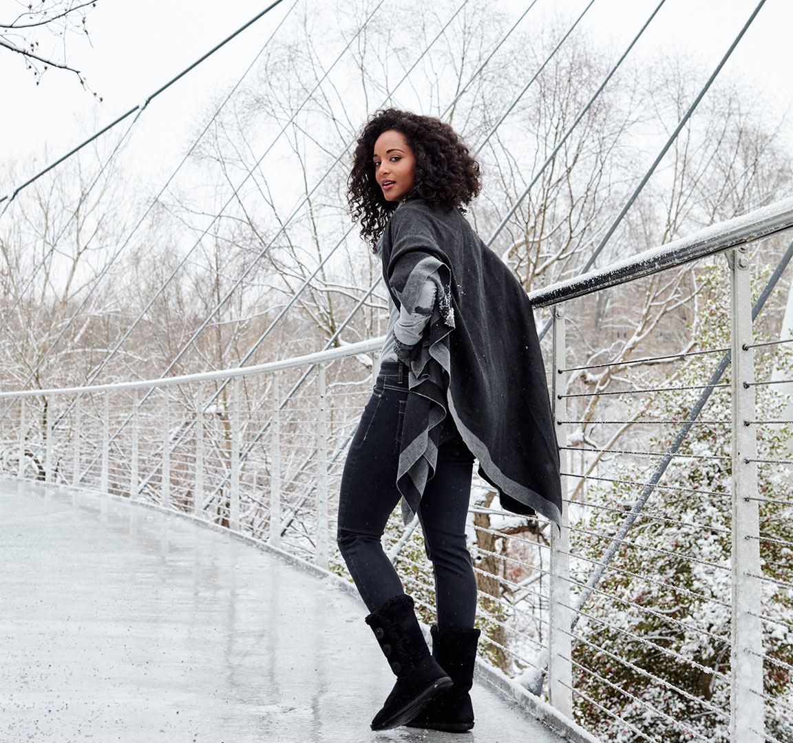Fashion model on snowy bridge photographed by commerical apparel photographer Kate Benson.