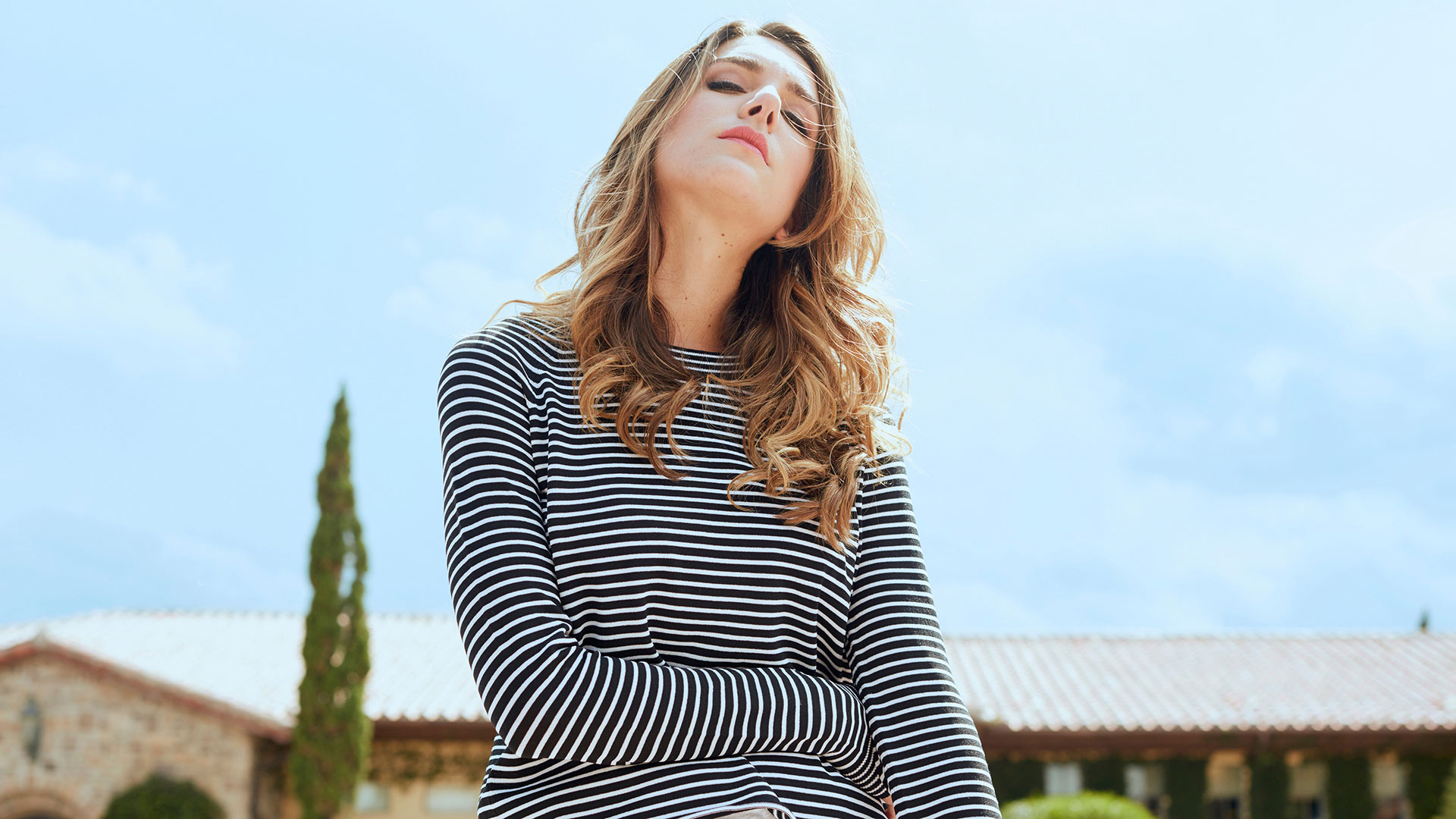 Fashion model in striped shirt on location photographed by commercial photographer Kate Benson.