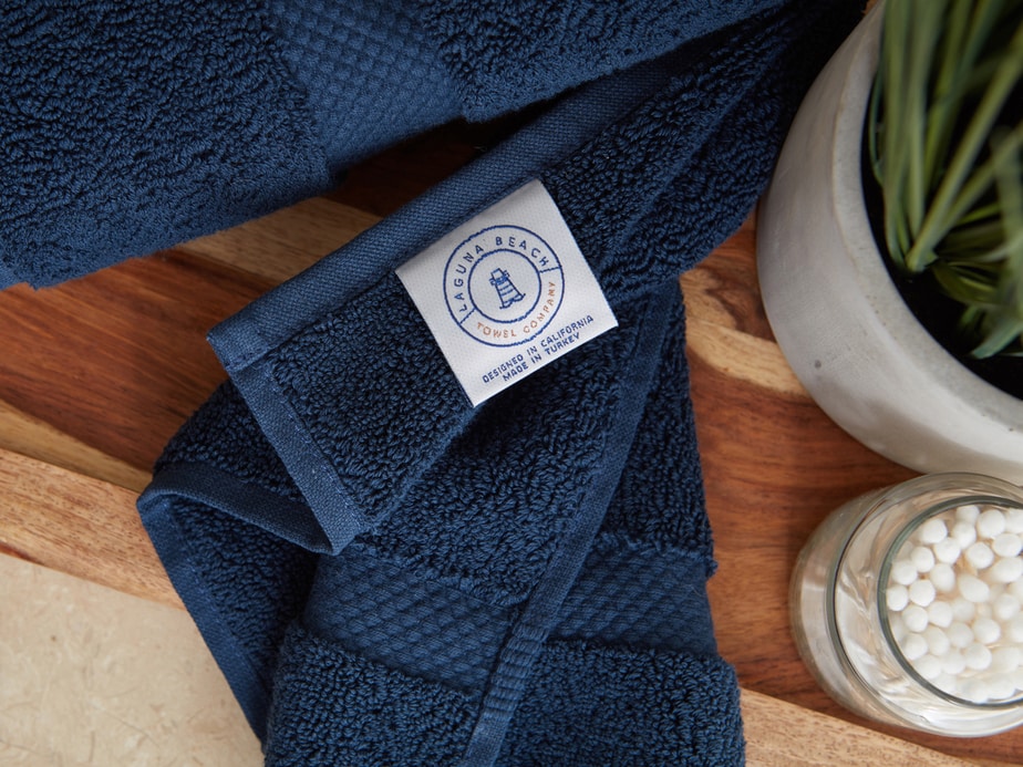 Towels hanging on ladder and laying on basket photographed by still life photographer Kate Benson.