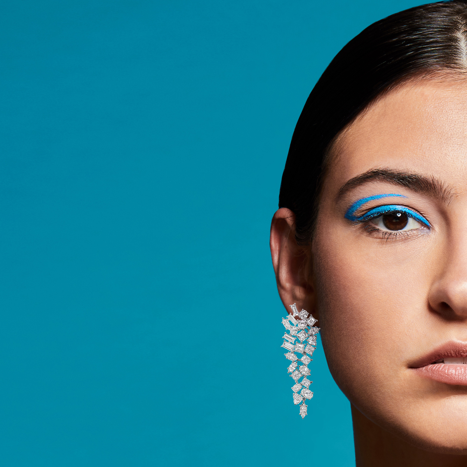 On model dangle diamond earring photographed by jewelry photographer Kate Benson.