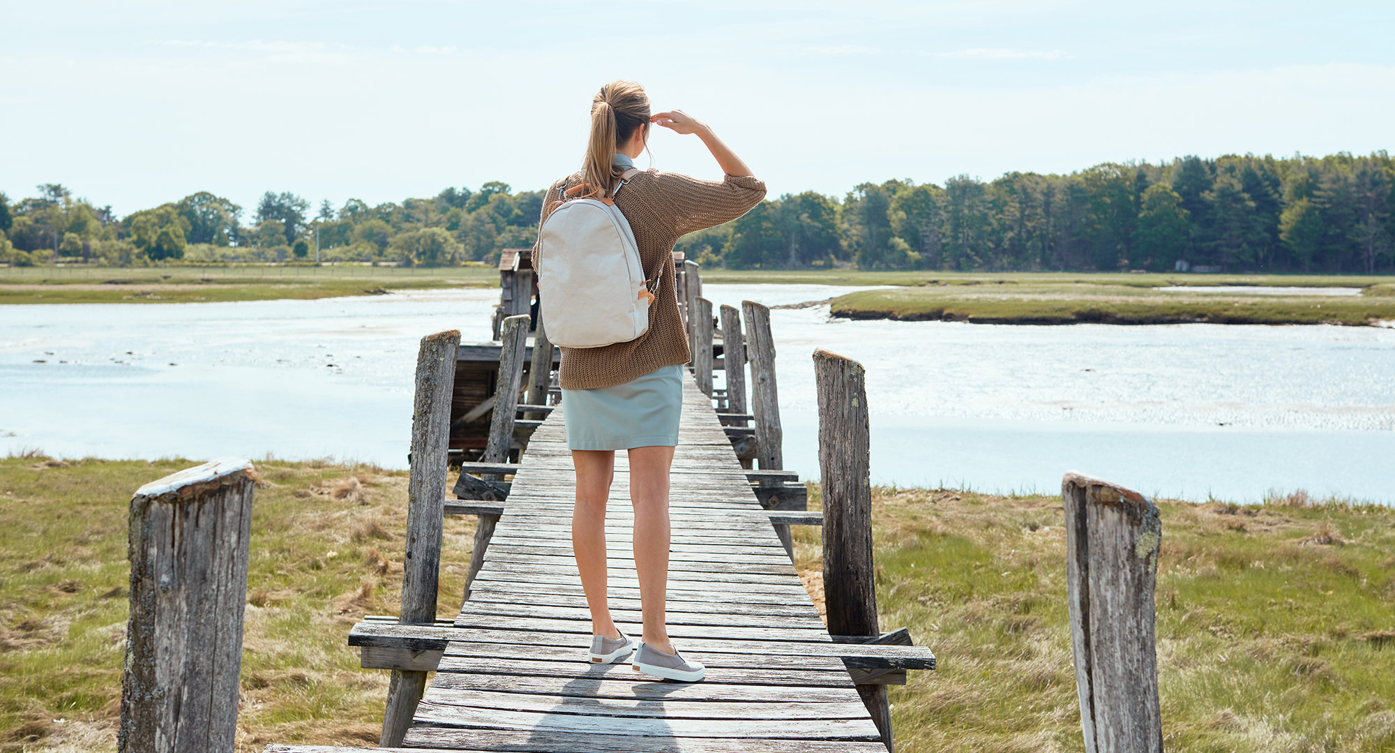 Lifestyle product photographer on location Kate Benson backpack on dock